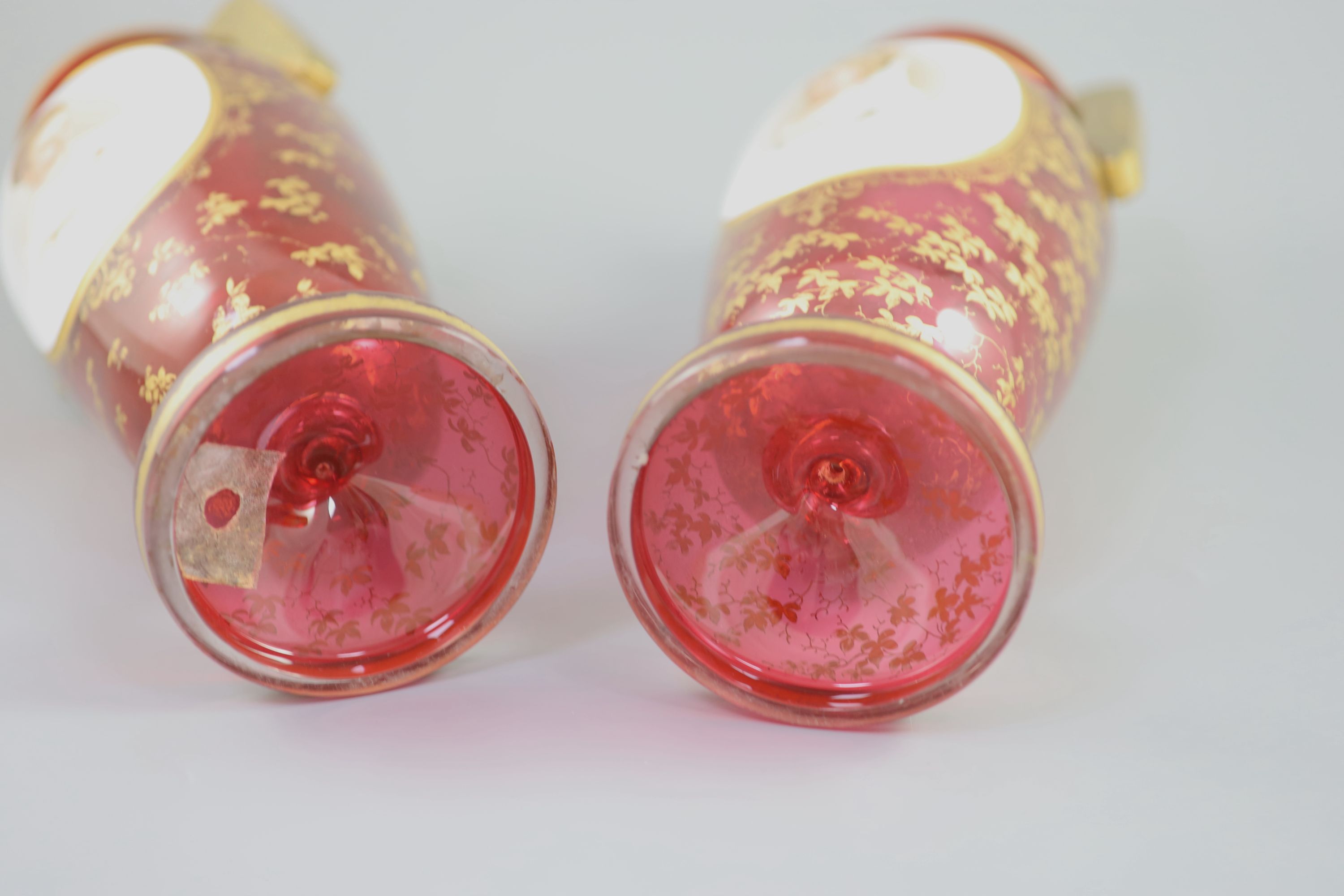 A pair of Bohemian gilt decorated ruby glass two handled vases, late 19th century, height 32cm